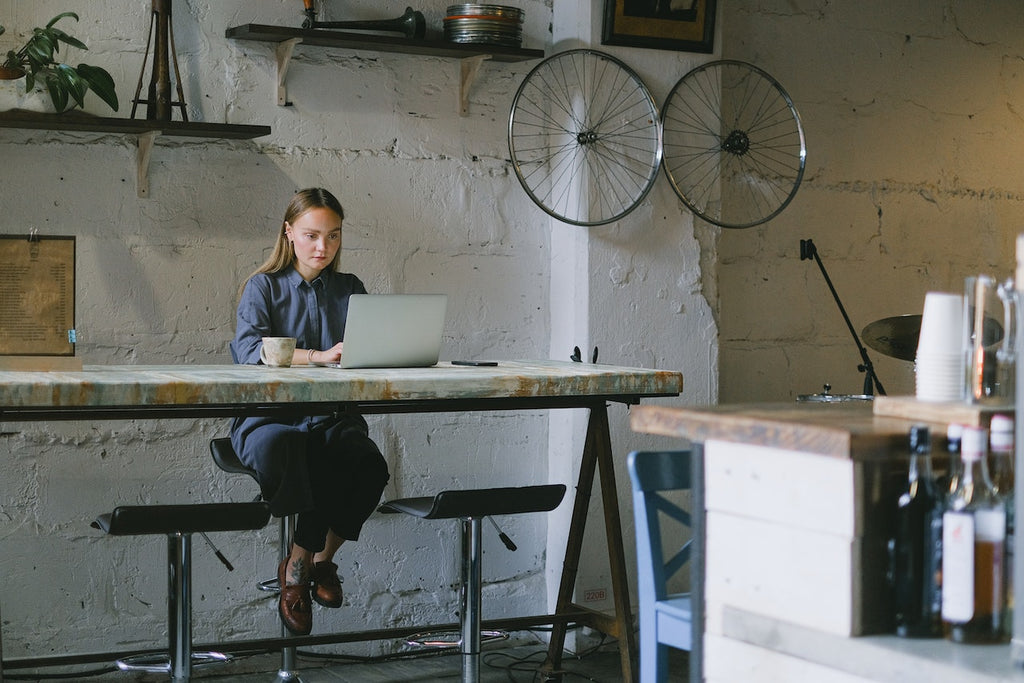 A woman on a high desk drinking CBD infused tea