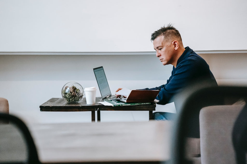 A focused man typing on a laptop